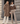 Two models wearing a tortora chevron fur coat and a brown shearling jacket with an off-white collar.